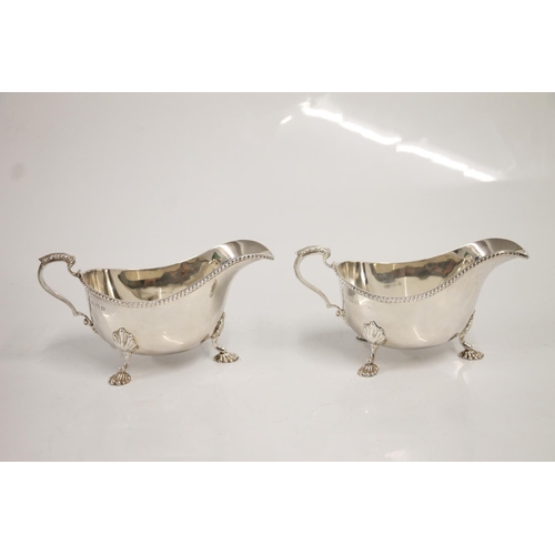 83 - Pair of Geo. VI silver sauce boats, having shaped notched border with acanthus scroll ear shaped han... 