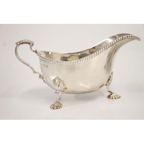 83 - Pair of Geo. VI silver sauce boats, having shaped notched border with acanthus scroll ear shaped han... 