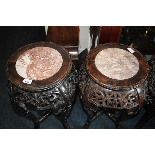 363 - Two Chinese hardwood jardiniere stands, late Qing period, the round tops inset with variegated marbl... 