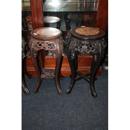 364 - Two Chinese hardwood jardiniere stands, late Qing period, the round tops inset with variegated marbl... 