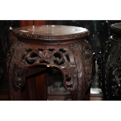 364 - Two Chinese hardwood jardiniere stands, late Qing period, the round tops inset with variegated marbl... 