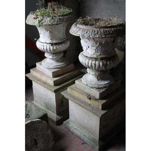 377 - Pair of painted stoneware campagna garden urns, of segmented construction on square pedestal bases, ... 