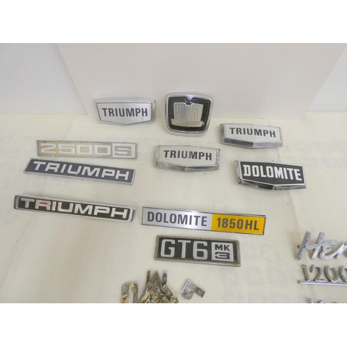 38 - Bag of vintage triumph car badges including GT6, Herald, Dolomite etc.