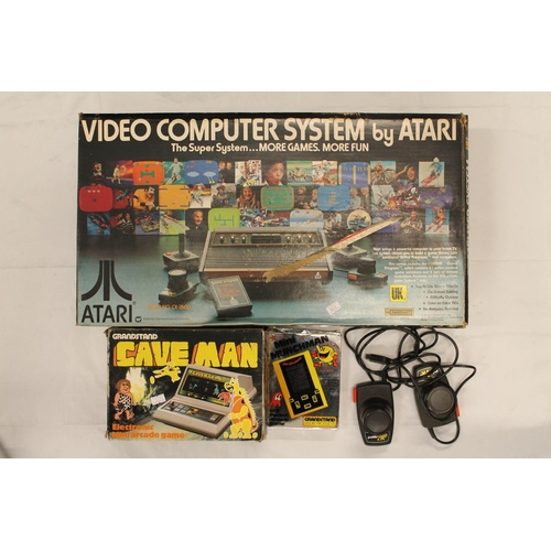 1204 - The Video Computer System by Atari model CX-2600 boxed, Grandstand Cave Man mini arcade game and ano... 