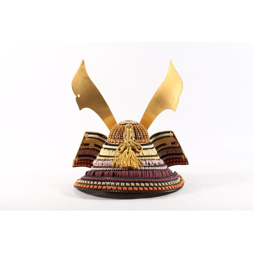 1457 - Model of a Japanese Samurai kabuto helmet, 32cm tall, held in a gilt metal bound black lacquer box.