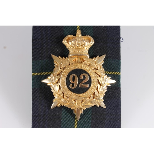 1440 - Gordon Highlanders gilded metal helmet plate badge of crowned wreath and star form with '92' in the ... 