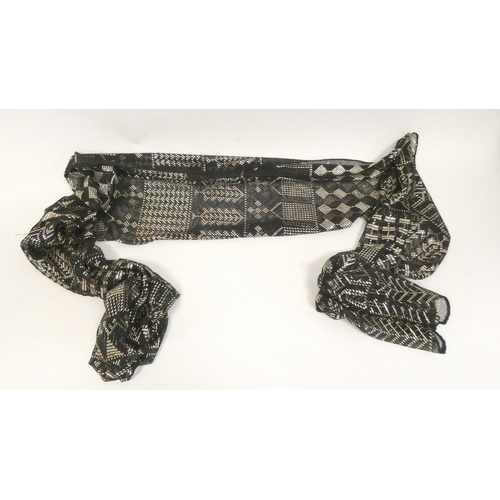 38 - Black cotton scarf with silver woven decoration, 616g gross.