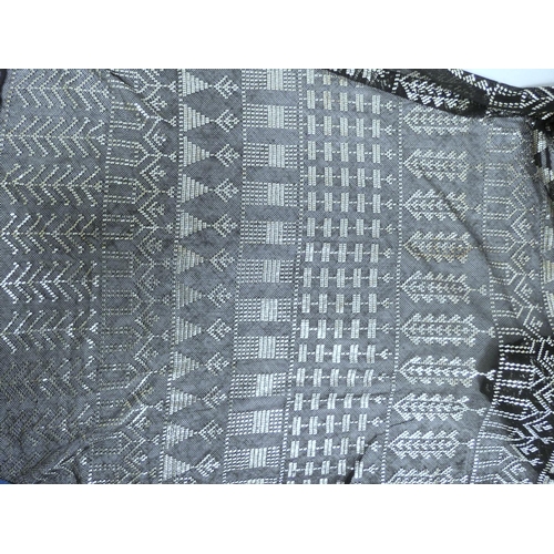 38 - Black cotton scarf with silver woven decoration, 616g gross.