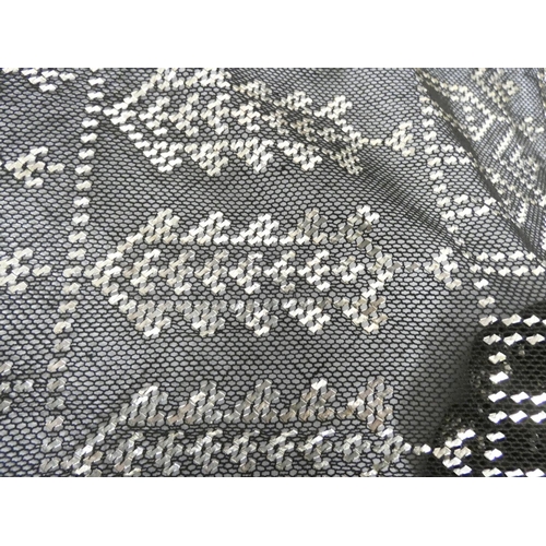 38 - Black cotton scarf with silver woven decoration, 616g gross.