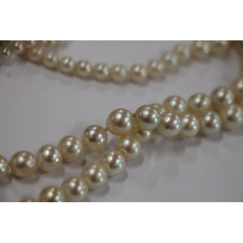 168 - Single strand pearl necklace with Art Deco style white metal closure set with diamonds, and a single... 