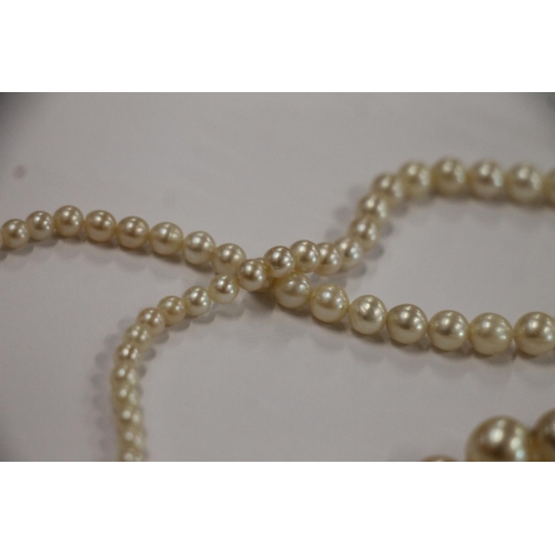 168 - Single strand pearl necklace with Art Deco style white metal closure set with diamonds, and a single... 