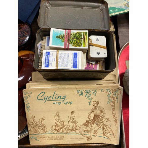 279 - Collection, cigarette album to include John Players, cycling, meat press, Tibetian figures, boo... 