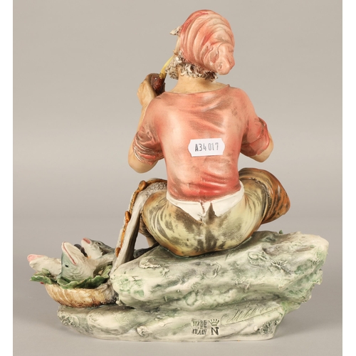 217 - Italian Capodimonte figure of a fisherman smoking a pipe with his catch marked N to base,