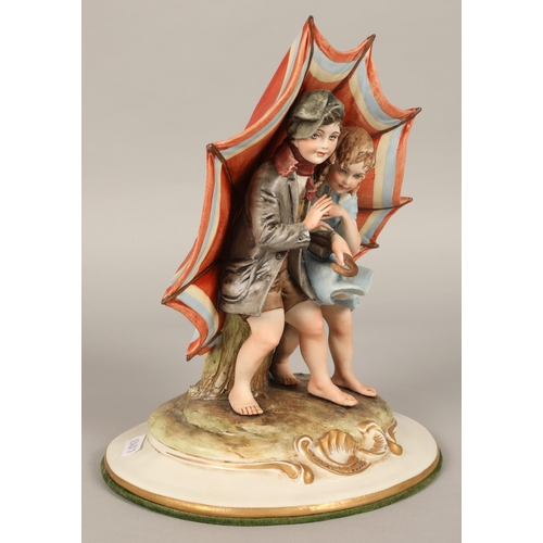 218 - Capodimonte figure of two children under an umbrella, 26cm h