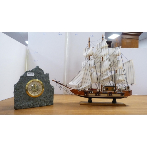 129 - Cased camera, binoculars, wooden gavel, three model boats, mantel clock etc (one shelf).