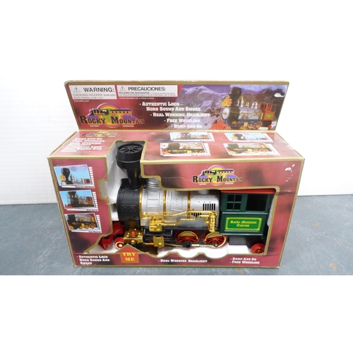 32 - Plastic box containing playworn and other vehicles, Rocky Mountain battery-operated locomotive and a... 