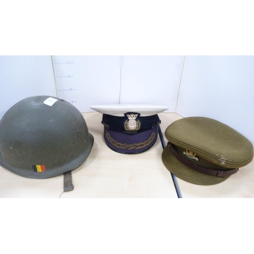 9 - Two military caps, helmet, shovel and a cased gas mask.