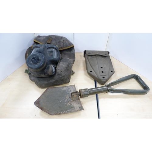 9 - Two military caps, helmet, shovel and a cased gas mask.