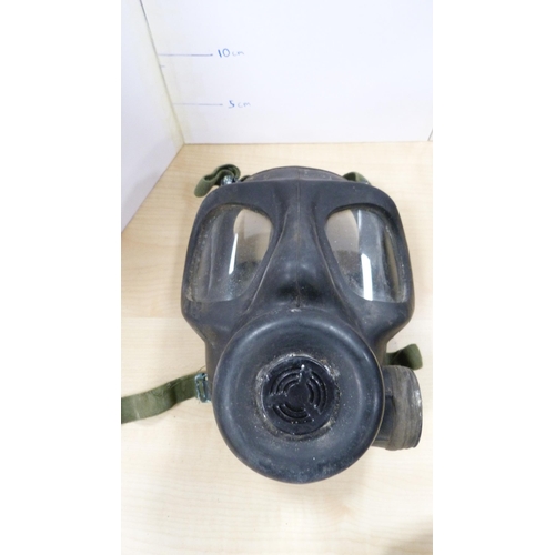 9 - Two military caps, helmet, shovel and a cased gas mask.