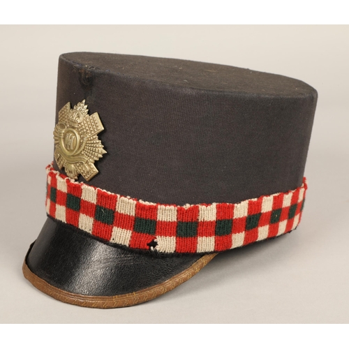 243 - Highland Light Infantry shako cap with badge and feather hackle, in carrying tin