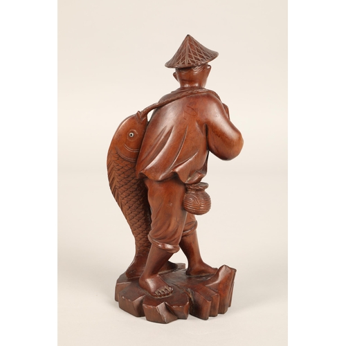 273 - Carved hardwood figure of a Chinese fisherman