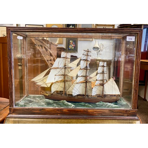 Model three masted sailing ship in glass display case
