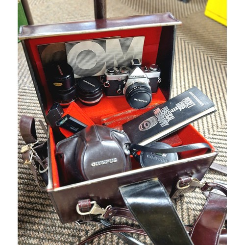 322 - Olympus OMI camera, lenses and accessories cased.