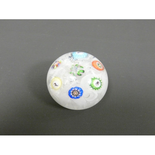 221 - Baccarat, spaced millefiori paperweight set with seven individual canes, including three Gridel silh... 