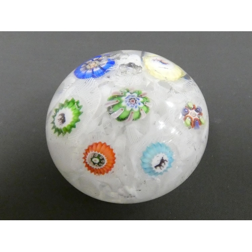 221 - Baccarat, spaced millefiori paperweight set with seven individual canes, including three Gridel silh... 