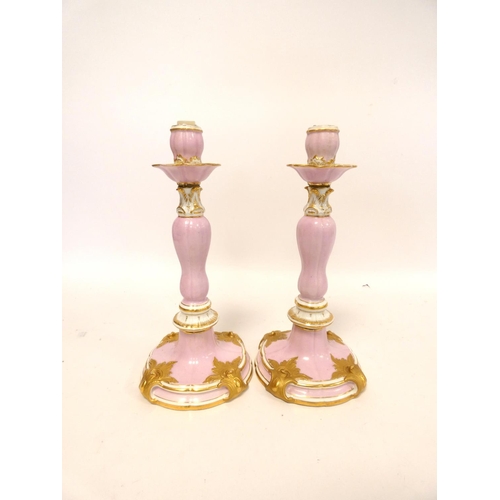 201 - Pair of continental porcelain candlesticks in the Meissen style decorated with applied gilded cartou... 