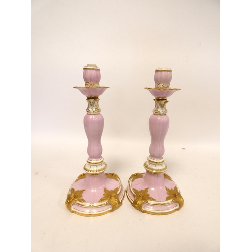 201 - Pair of continental porcelain candlesticks in the Meissen style decorated with applied gilded cartou... 