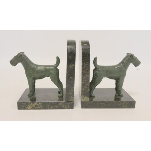 242 - Pair of cold painted terrier bookends on a mottled marble effect base. 15cm high.