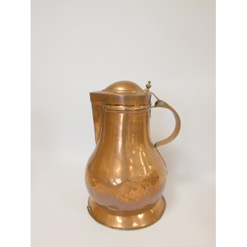 244 - Arts and Crafts style copper flagon with hinged cover with stylised handle, 37cm high, with a copper... 