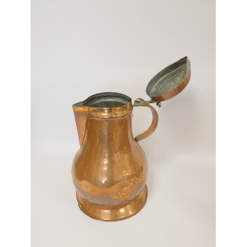 244 - Arts and Crafts style copper flagon with hinged cover with stylised handle, 37cm high, with a copper... 