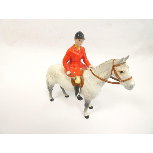 213 - Beswick Huntsman porcelain figure of a Huntsman on a mottled grey horse, model no.1501. Height 21cm