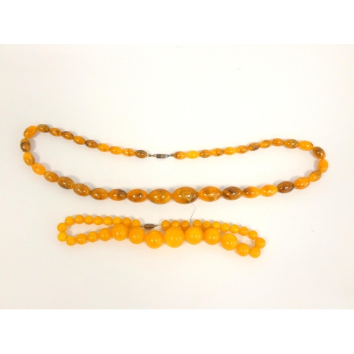 81 - Two graduated composite amber necklaces. Length 75cm & 45cm. (2)