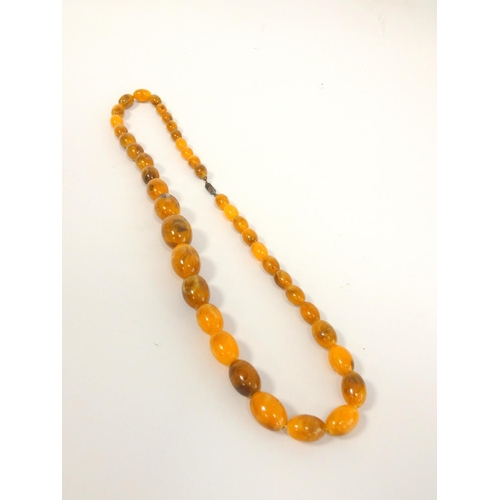 81 - Two graduated composite amber necklaces. Length 75cm & 45cm. (2)