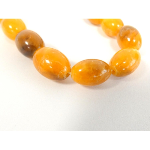 81 - Two graduated composite amber necklaces. Length 75cm & 45cm. (2)