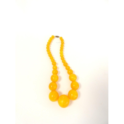 81 - Two graduated composite amber necklaces. Length 75cm & 45cm. (2)