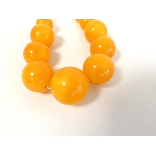 81 - Two graduated composite amber necklaces. Length 75cm & 45cm. (2)