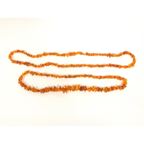 82 - Two strung raw amber necklaces. Length 29cm & 36cm. (2)