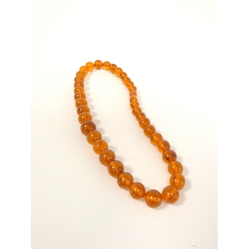 83 - Amber jewellery to include a strung raw amber necklace, length 32cm, amber bead necklace, length 44c... 