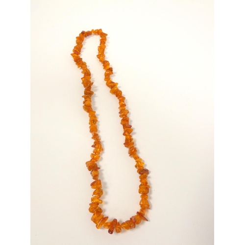 83 - Amber jewellery to include a strung raw amber necklace, length 32cm, amber bead necklace, length 44c... 