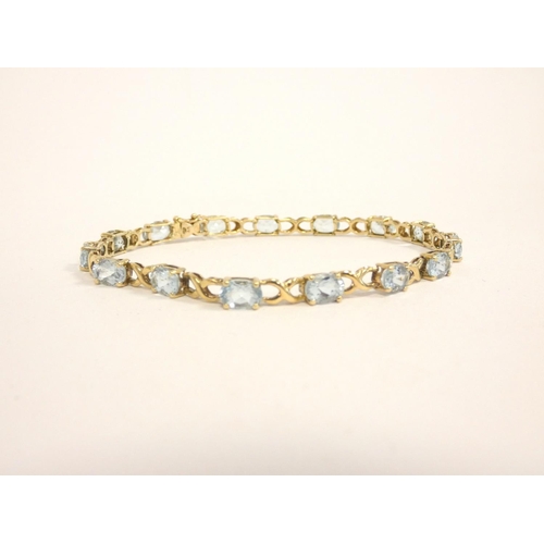 84 - 9ct gold and aquamarine tennis bracelet, length 21cm, 9g.