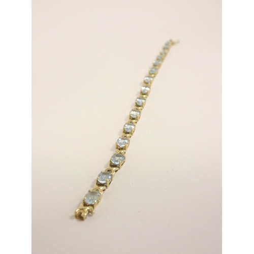 84 - 9ct gold and aquamarine tennis bracelet, length 21cm, 9g.