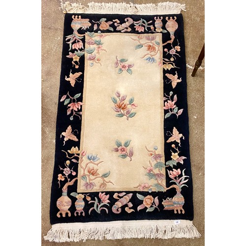 590 - Black and cream ground Chinese rug