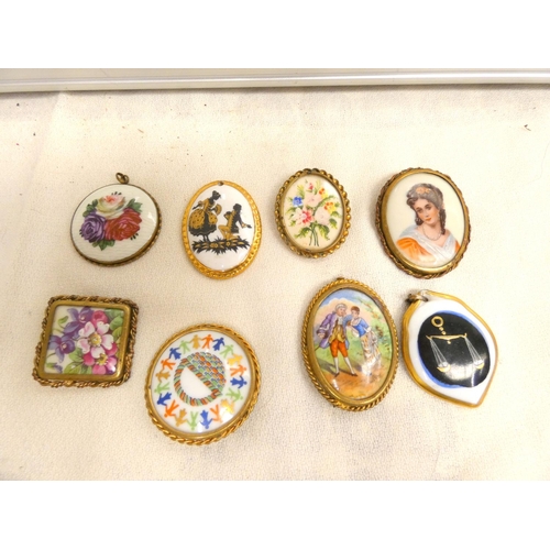 102 - Eight porcelain brooches to include Limoges, Rosenthal etc.