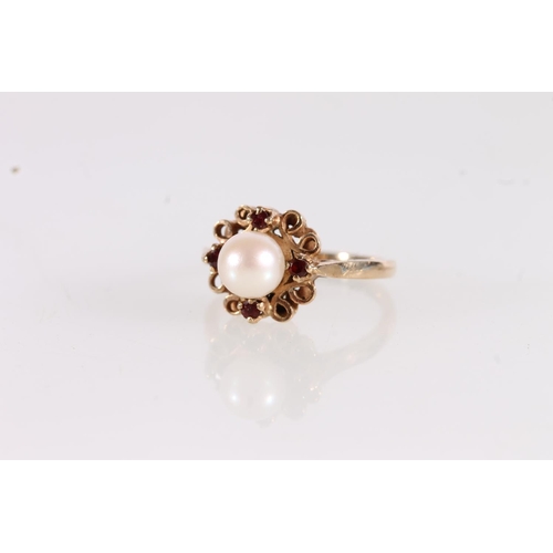 503 - 9ct gold ring set with large spherical pearl on a flowerhead mount, ring size K, 3g gross.