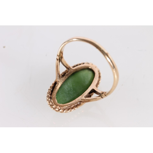 504 - 9ct gold dress ring set with a large New Zealand pounamu jade green cabochon stone of navette shape,... 