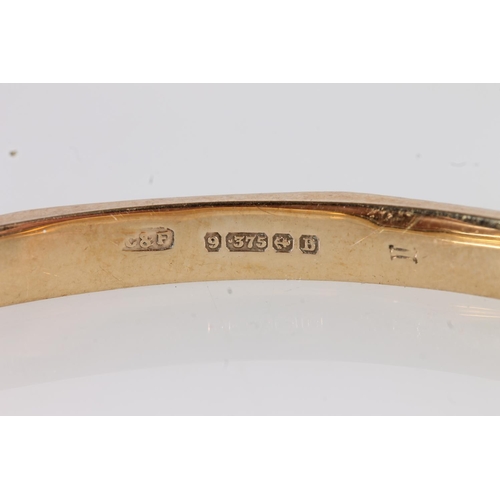 521 - 9ct gold bangle with Greek key engraved design, internal W7cm, 8.4g.